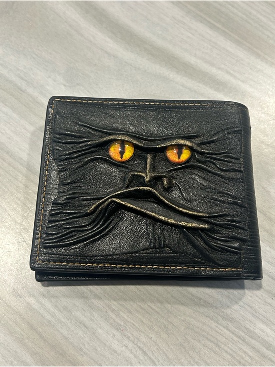 Other - Men's Black Leather Bi-Fold Wallet with Embossed Face and Yellow Eye Accent